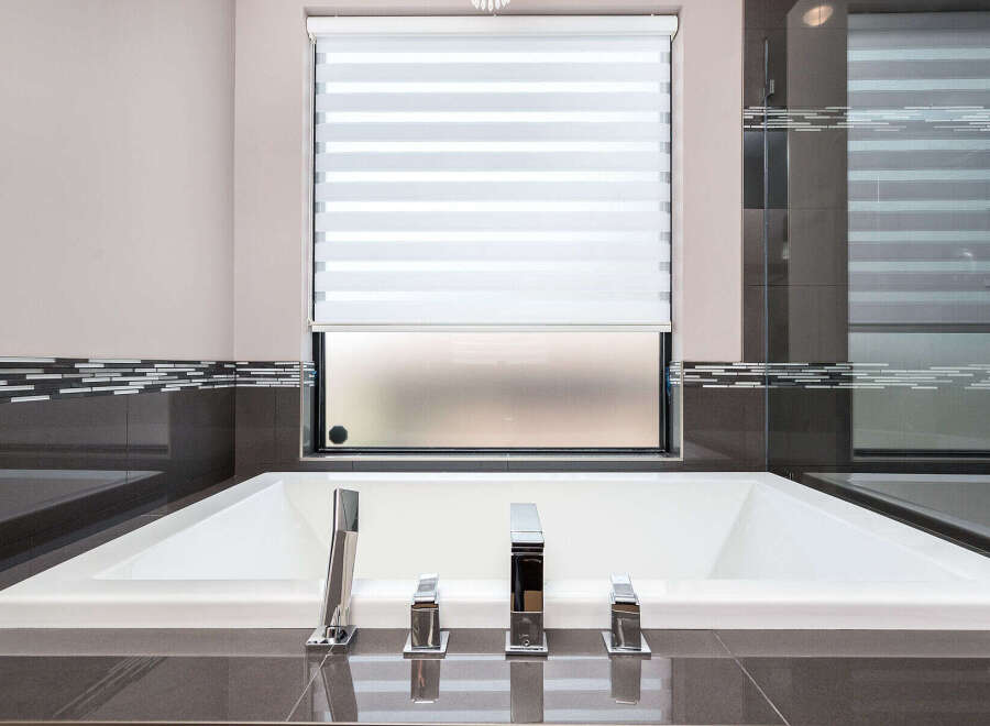 Indulge in luxury with this stunning bathroom featuring a modern soaking tub.