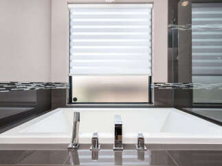 Indulge in luxury with this stunning bathroom featuring a modern soaking tub.