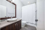 This modern bathroom features a sleek vanity with a stylish vessel sink and a large mirror.