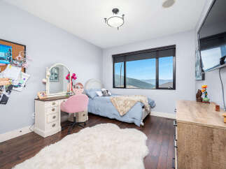 This charming bedroom offers a cozy and inviting atmosphere, perfect for relaxation.