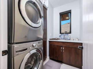 This modern laundry room features a sleek, stacked LG washer and dryer, maximizing space and efficiency.