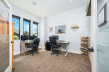 This modern home office offers a bright and airy workspace with ample natural light.