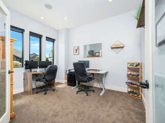 This modern home office offers a bright and airy workspace with ample natural light.