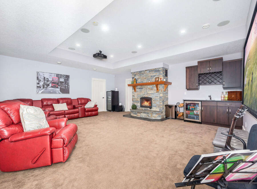 Step into luxury with this stunning living space, featuring a cozy fireplace and a stylish wet bar, perfect for entertaining.
