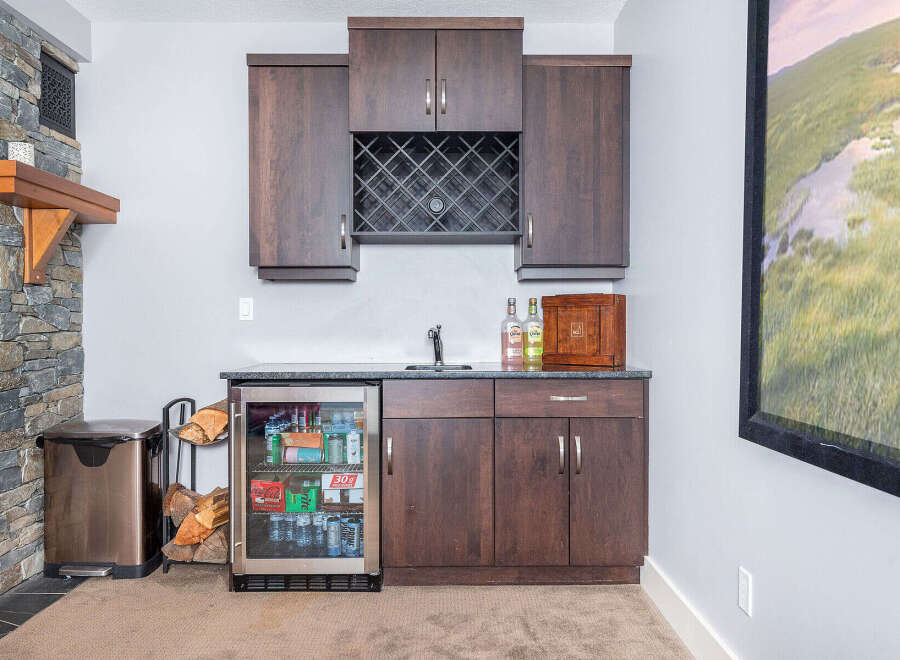 This stunning home features a beautifully designed wet bar, perfect for entertaining guests.