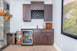 This stunning home features a beautifully designed wet bar, perfect for entertaining guests.