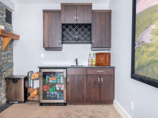 This stunning home features a beautifully designed wet bar, perfect for entertaining guests.