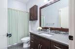 This stunning bathroom boasts a modern design with a sleek vanity and a spacious countertop.