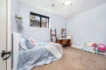 This charming bedroom offers a cozy retreat with its soft color palette and inviting ambiance.