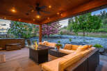 Experience luxury living in this stunning outdoor oasis! This property boasts a cozy seating area with a fire pit, perfect for entertaining or relaxing.