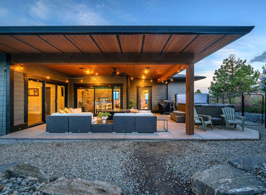 Enjoy luxurious outdoor living in this stunning property! Featuring a spacious patio with comfortable seating, a hot tub, and a beautifully designed covered area, perfect for entertaining or relaxing.