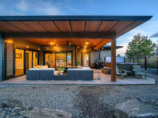 Enjoy luxurious outdoor living in this stunning property! Featuring a spacious patio with comfortable seating, a hot tub, and a beautifully designed covered area, perfect for entertaining or relaxing.
