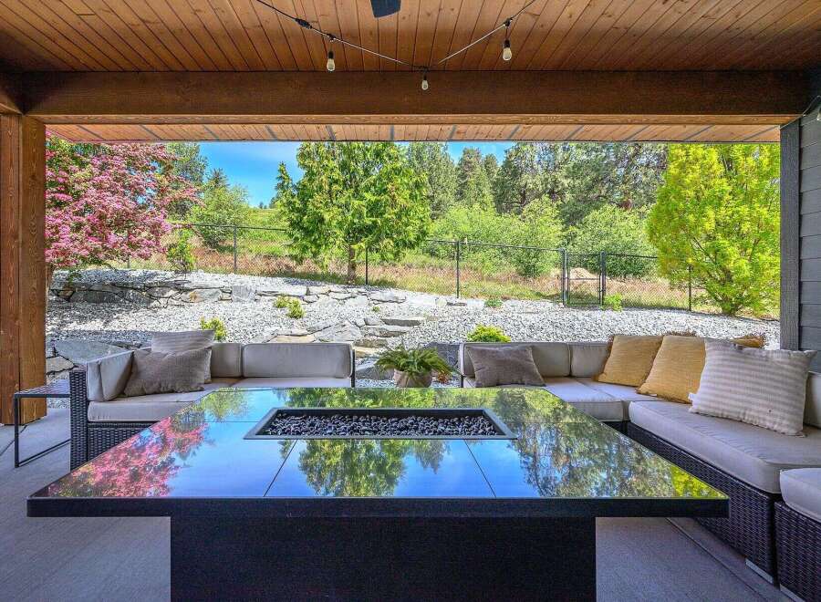 Experience luxury living in this stunning outdoor oasis! This property features a modern fire pit, perfect for cozy evenings and entertaining guests.
