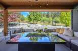 Experience luxury living in this stunning outdoor oasis! This property features a modern fire pit, perfect for cozy evenings and entertaining guests.