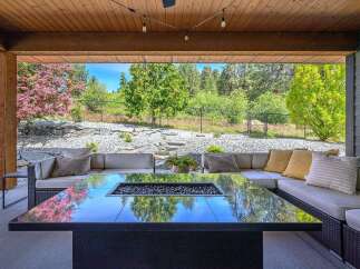 Experience luxury living in this stunning outdoor oasis! This property features a modern fire pit, perfect for cozy evenings and entertaining guests.