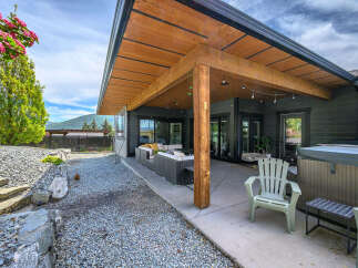 Enjoy outdoor living at its finest with this stunning property featuring a covered patio, perfect for entertaining or relaxing.