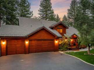 This stunning property boasts a beautiful wooden exterior and a charming design.