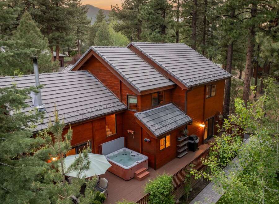 Nestled in a serene, wooded setting, this stunning property boasts a luxurious hot tub, perfect for relaxation.
