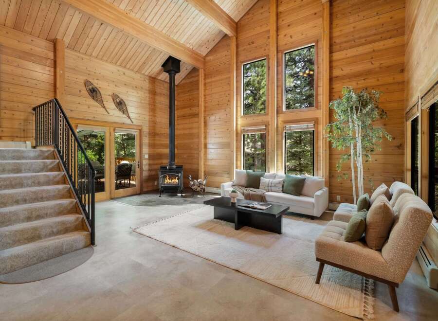 Step into luxury with this stunning property featuring a cozy fireplace and expansive windows that flood the space with natural light.