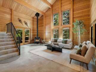 Step into luxury with this stunning property featuring a cozy fireplace and expansive windows that flood the space with natural light.