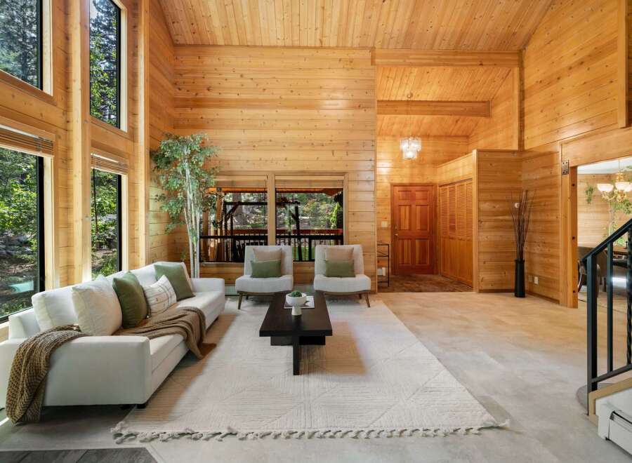 Step into this stunning home featuring a warm and inviting interior with beautiful wood paneling throughout.