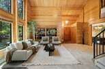 Step into this stunning home featuring a warm and inviting interior with beautiful wood paneling throughout.