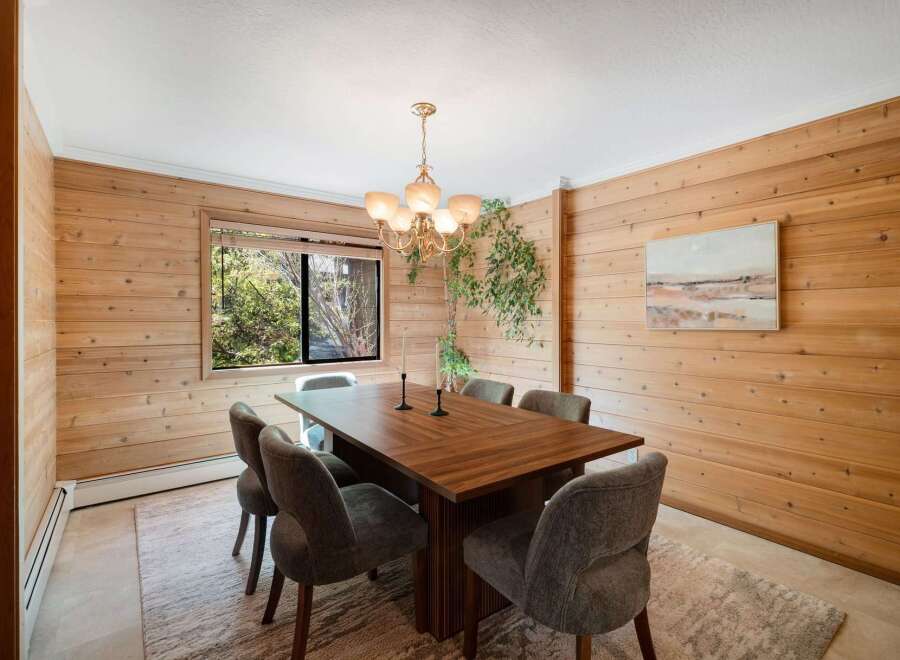 Step into this inviting dining room, featuring stunning wood paneling that adds warmth and character.