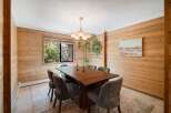 Step into this inviting dining room, featuring stunning wood paneling that adds warmth and character.