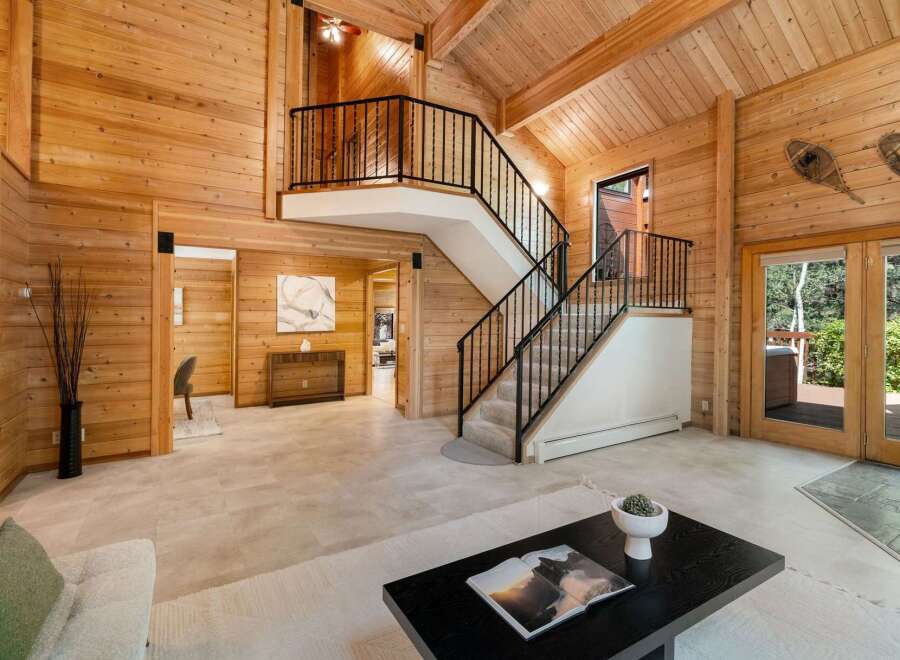 Step into luxury with this stunning home featuring a grand staircase and exquisite wooden accents throughout.