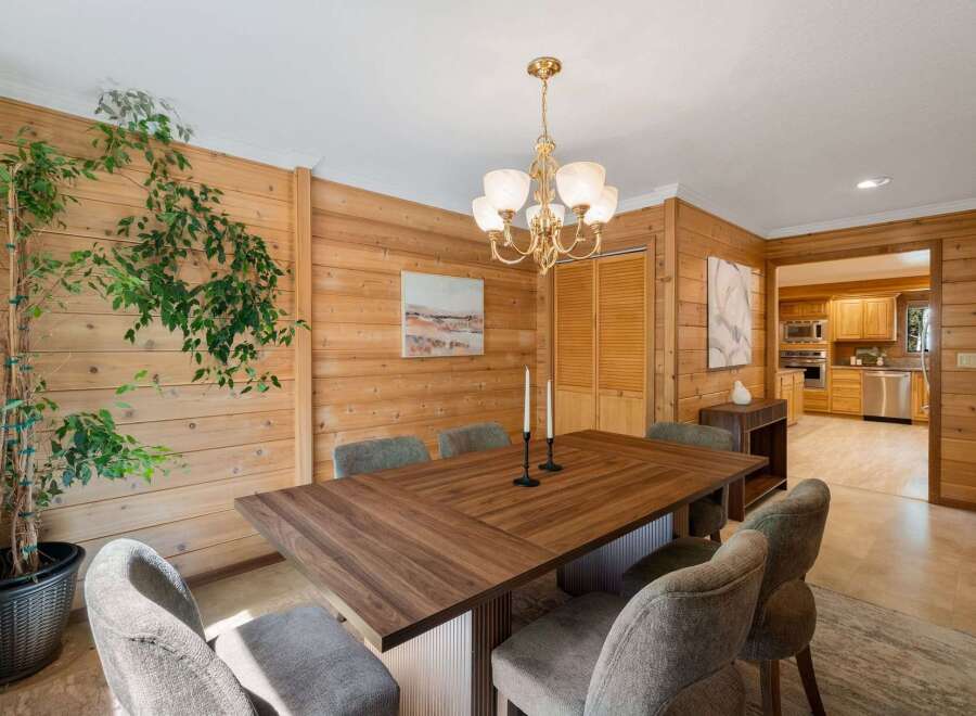 Step into this inviting dining room, featuring a stunning wood-paneled wall that adds warmth and character.