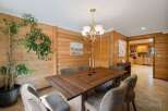 Step into this inviting dining room, featuring a stunning wood-paneled wall that adds warmth and character.