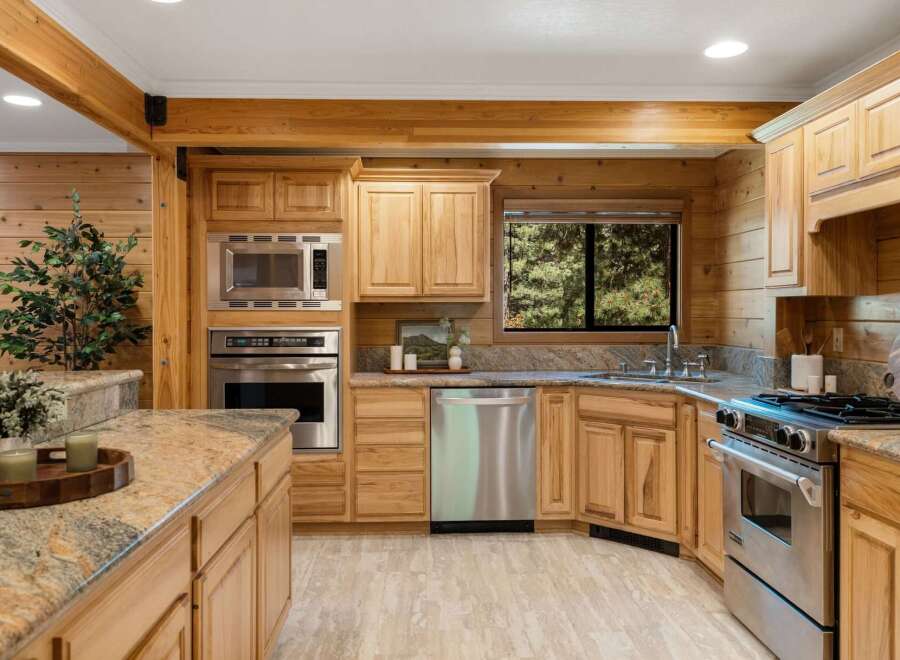 Step into a beautifully designed kitchen featuring custom cabinetry and stainless steel appliances.