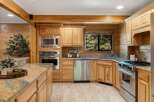 Step into a beautifully designed kitchen featuring custom cabinetry and stainless steel appliances.