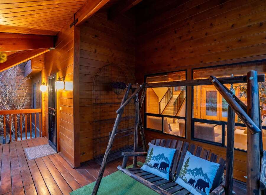 Step into rustic charm with this inviting porch, perfect for relaxing and enjoying the surrounding natural beauty.