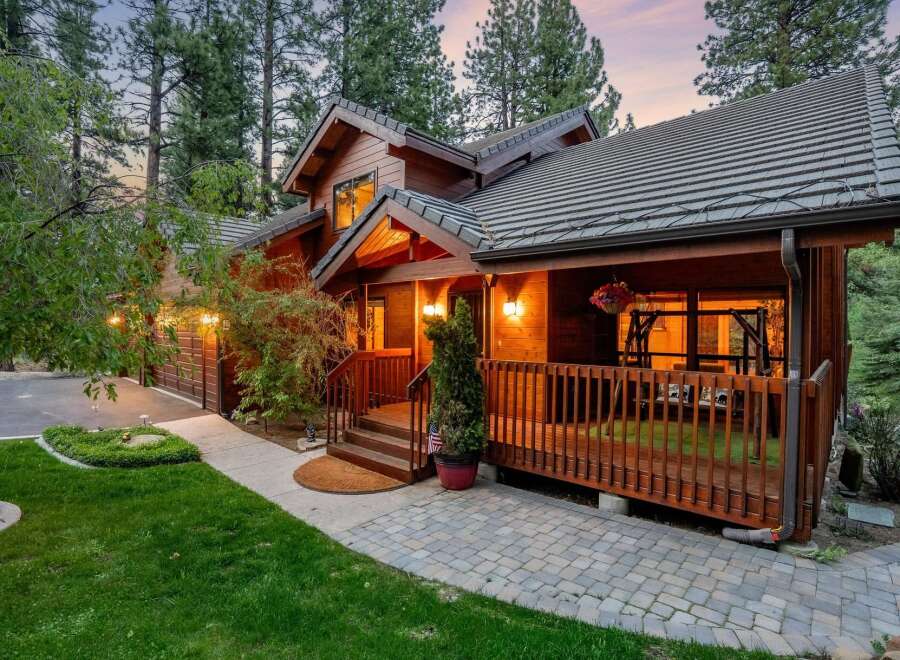 Discover the charm of this stunning wooden cabin nestled in a serene, tree-lined setting.