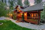 Discover the charm of this stunning wooden cabin nestled in a serene, tree-lined setting.