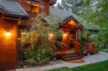This stunning property boasts a warm and inviting exterior with beautiful wood siding and a charming front porch.