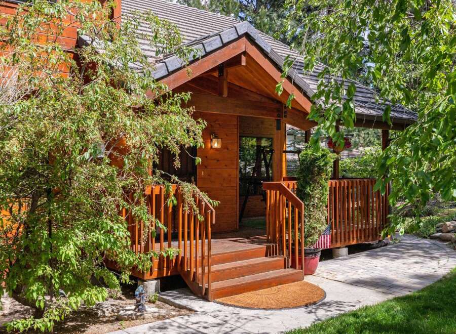 This charming wooden cabin offers a warm and inviting entrance, perfect for a cozy retreat.