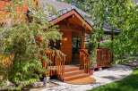 This charming wooden cabin offers a warm and inviting entrance, perfect for a cozy retreat.