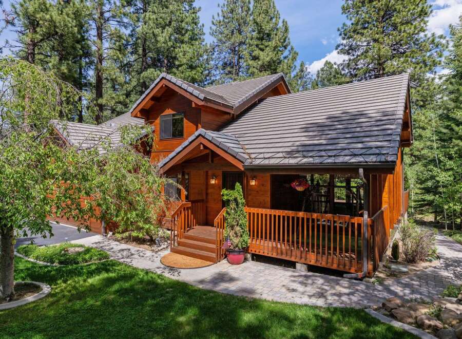 Nestled amidst lush greenery, this stunning wooden home offers a serene retreat.