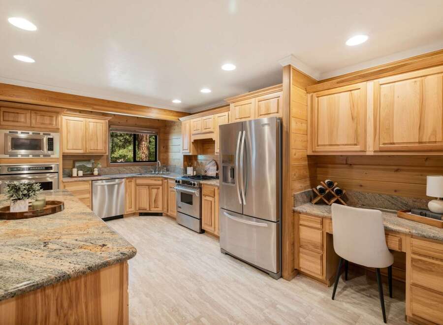 Step into this stunning kitchen, boasting custom wood cabinetry and sleek stainless steel appliances.