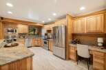 Step into this stunning kitchen, boasting custom wood cabinetry and sleek stainless steel appliances.