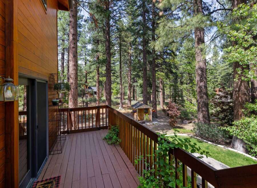 Enjoy the tranquility of nature from this stunning property! This home features a spacious deck, perfect for relaxing and taking in the surrounding forest views.