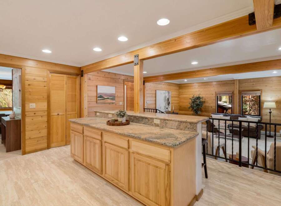 Step into this stunning home featuring a beautifully designed kitchen with custom cabinetry and granite countertops.