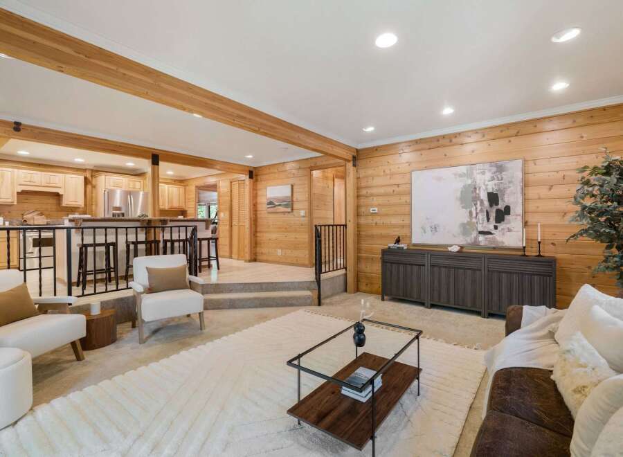 Step into this inviting living space, featuring stunning wood paneling that exudes warmth and character.