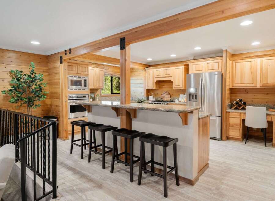 This stunning kitchen boasts a warm and inviting atmosphere with its beautiful wooden cabinetry and countertops.