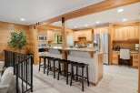 This stunning kitchen boasts a warm and inviting atmosphere with its beautiful wooden cabinetry and countertops.