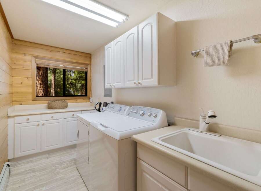 This charming laundry room features a bright and airy design, perfect for tackling chores.