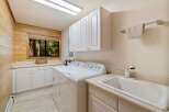 This charming laundry room features a bright and airy design, perfect for tackling chores.