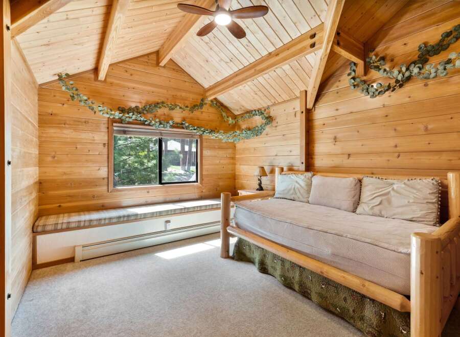 This cozy bedroom features a rustic wooden interior, creating a warm and inviting atmosphere.
